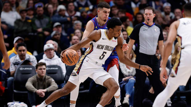 Jan 12, 2024; Denver, Colorado, USA; New Orleans Pelicans forward Herb Jones (5) controls the ball ahead of Denver Nuggets forward Michael Porter Jr. (1) in the third quarter at Ball Arena. 